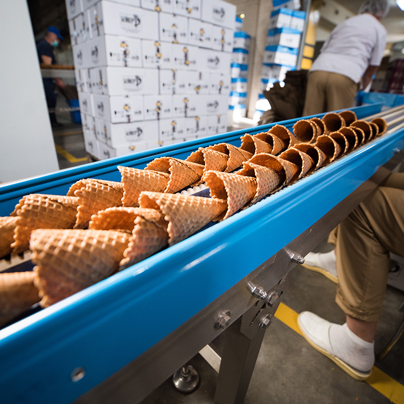 Ice cream cones being produced by a manufacturer.